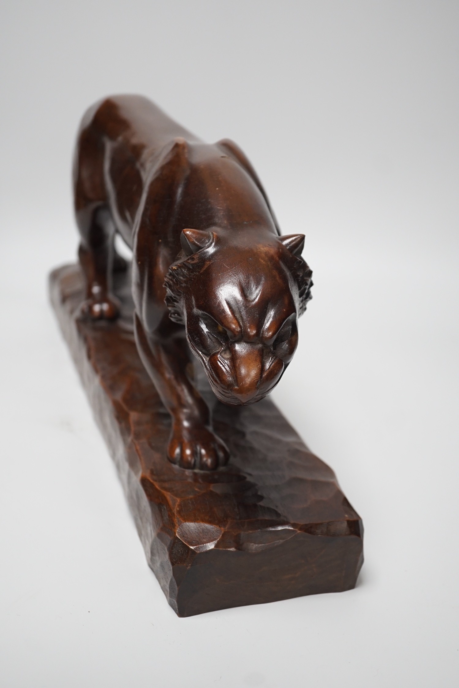 A French carved walnut model of a tiger, signed Chartron, 47cms wide